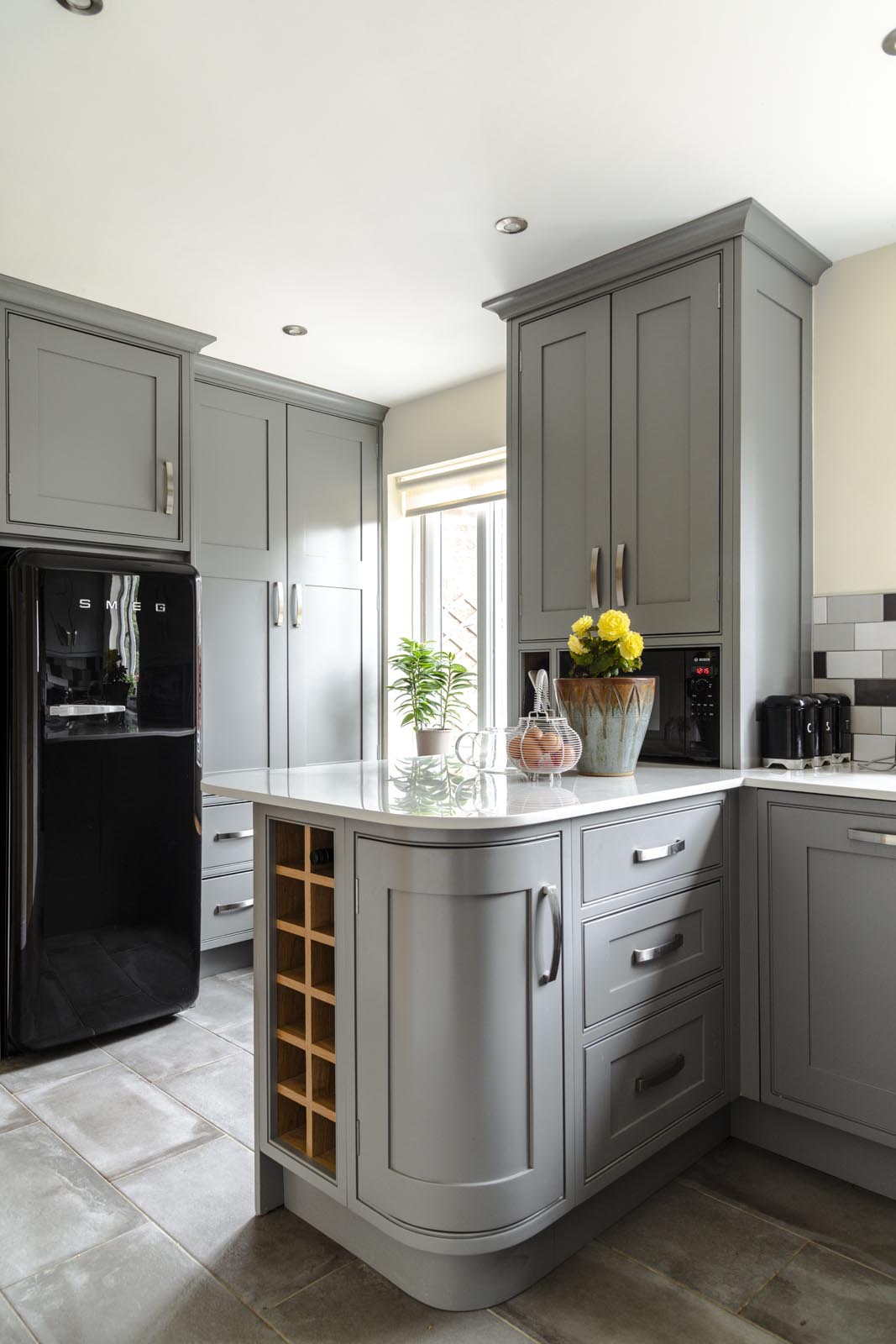 Custom made kitchen. A section of the kitchen shows a unit with corner cupboard and wine rack
